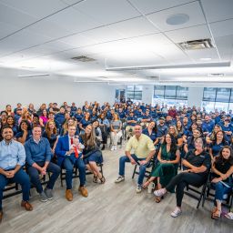 a group of people in a conference room sitting on chairs