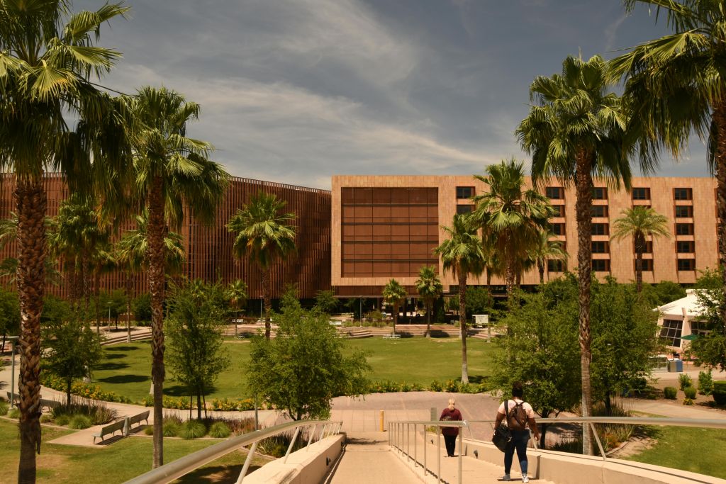 A building with palm trees and a walkway