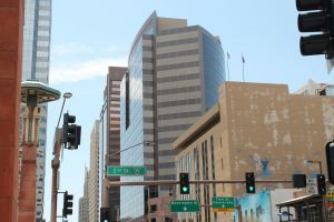 Downtown buildings and street signs behind traffic lights