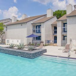 An apartment complex pool and building