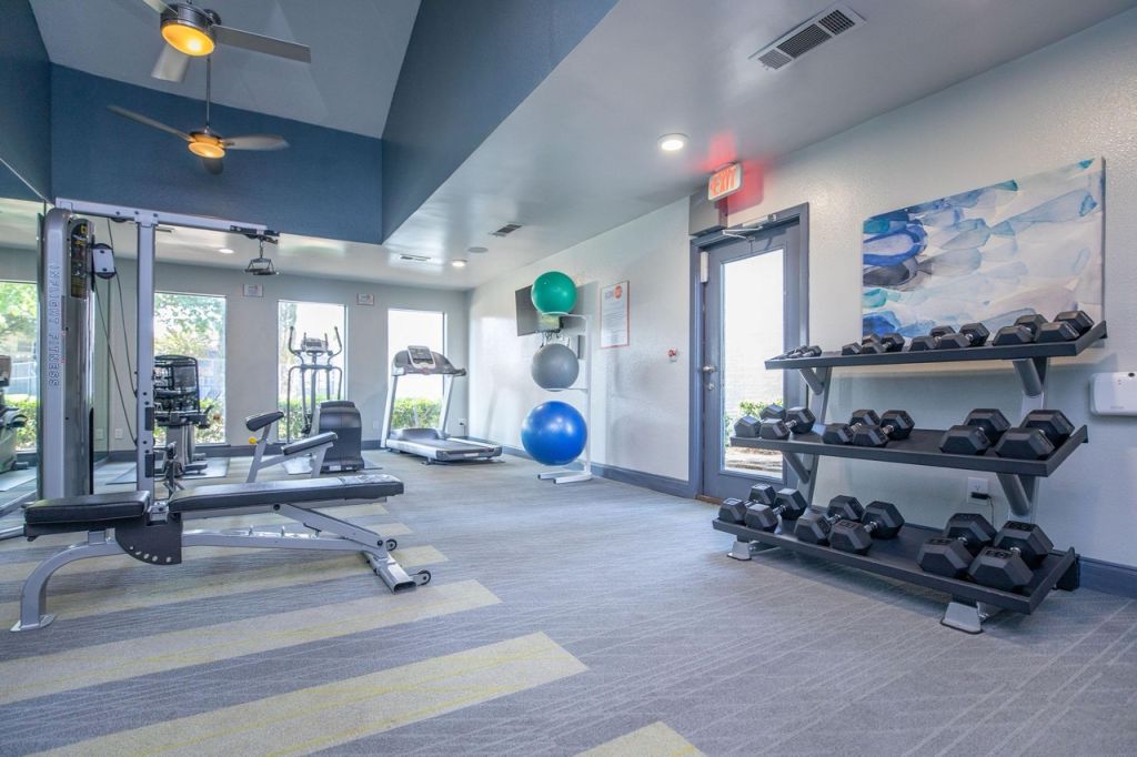 A room with exercise equipment and a fan