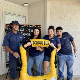 A group of people posing with a yellow inflatable object