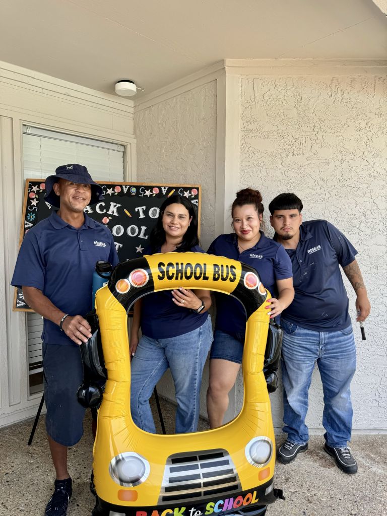 A group of people posing with a yellow inflatable object